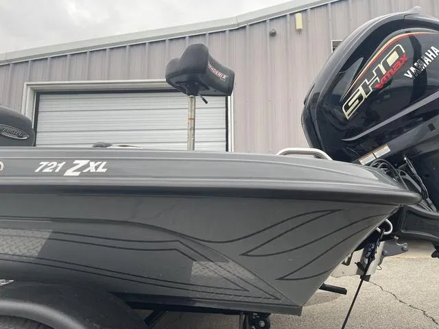 Slide: The Image of 2025 Phoenix 721 ZXL boat with Yamaha engine, parked near a garage. - 3