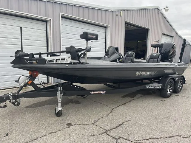 Slide: The Image of 2025 Phoenix 721 ZXL boat on trailer outside a garage. - 7