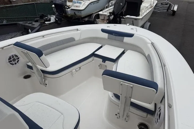 Slide: The Image of 2025 Robalo R 202 EX boat interior with cushioned seating and storage compartments. - 10
