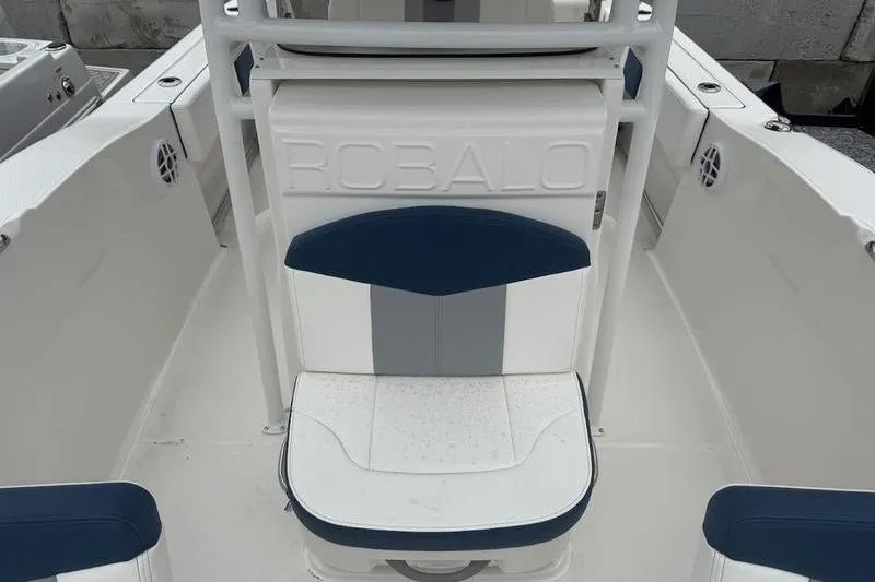Slide: The Image of 2025 Robalo R 202 EX boat interior with cushioned seating and sleek design. - 13