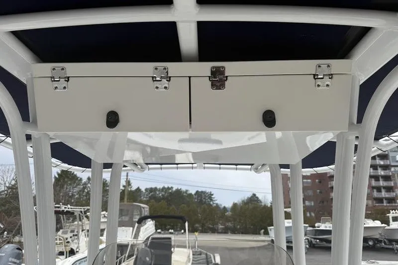 Slide: The Image of 2025 Robalo R 202 EX boat with overhead storage compartment and sturdy framework. - 14