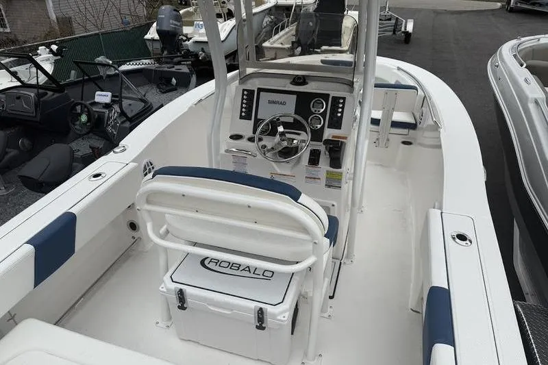 Slide: The Image of 2025 Robalo R 202 EX boat interior with steering console and seating. - 4