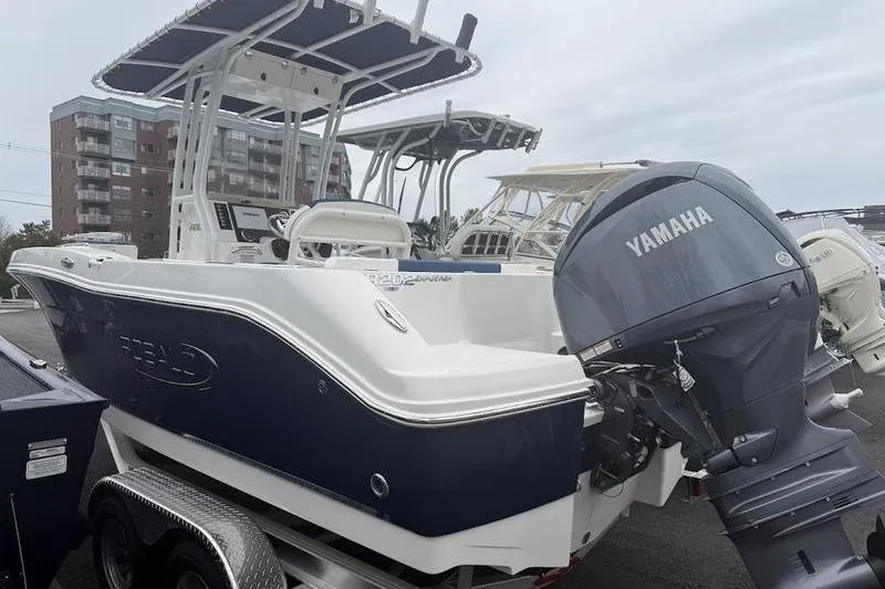 Slide: The Image of 2025 Robalo R 202 EX boat with Yamaha outboard motor, parked on a trailer. - 7