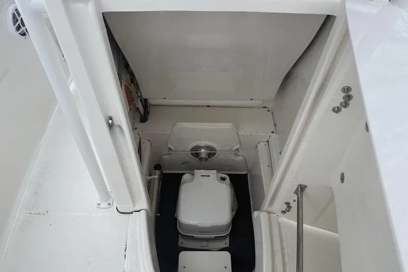 Slide: The Image of 2025 Robalo R 202 EX boat interior with compact marine toilet. - 8