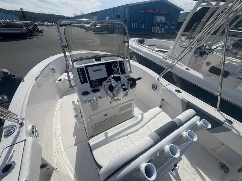Slide: The Image of 2025 Robalo R 180 CC boat interior with steering console and seating. - 11