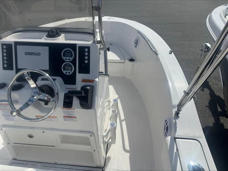 Slide: The Image of 2025 Robalo R 180 CC boat interior with steering wheel and control panel. - 4