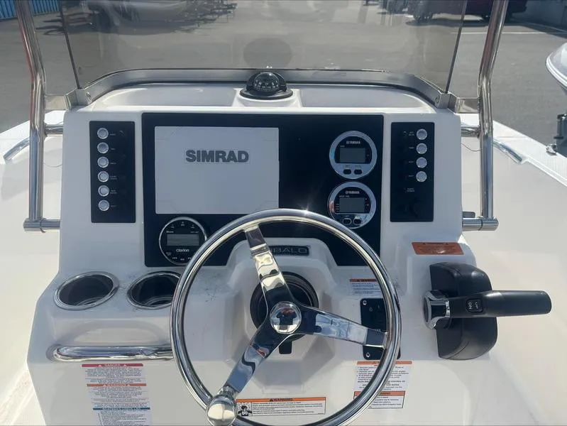 Slide: The Image of 2025 Robalo R 180 CC boat dashboard with Simrad navigation system and steering wheel. - 5