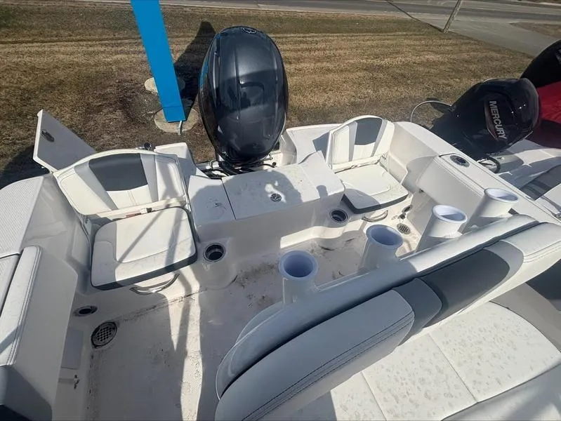 Slide: The Image of 2025 Robalo R 180 CC boat interior with seating and motor, showcasing modern design. - 6