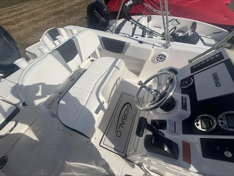 Slide: The Image of 2025 Robalo R 180 CC boat interior with steering wheel and seating. - 7