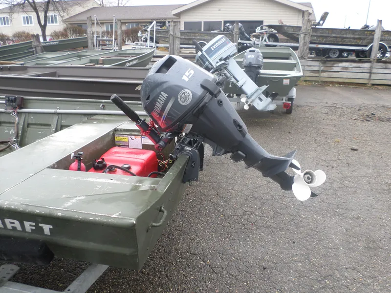 Slide: The Image of 2014 Alumacraft MV1648 boat with Yamaha 15HP outboard motor in a parking lot. - 3