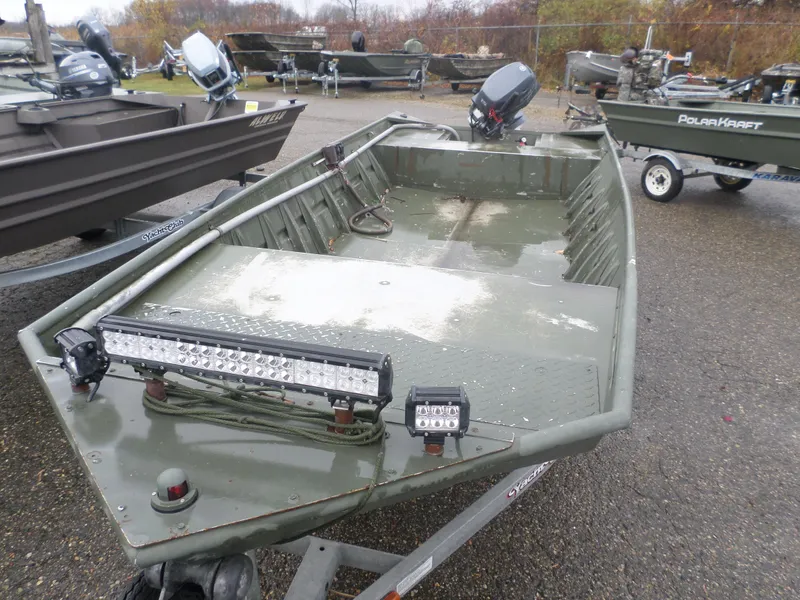Slide: The Image of 2014 Alumacraft MV1648 boat with LED lights, parked on a trailer. - 4