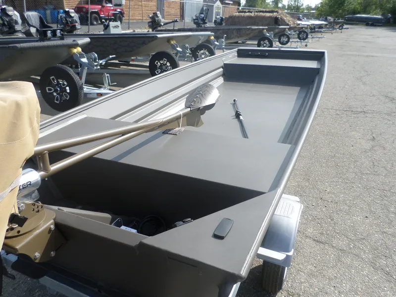 Slide: The Image of 2025 Alweld 1542 Marsh Jon boat on trailer, parked outdoors. - 3