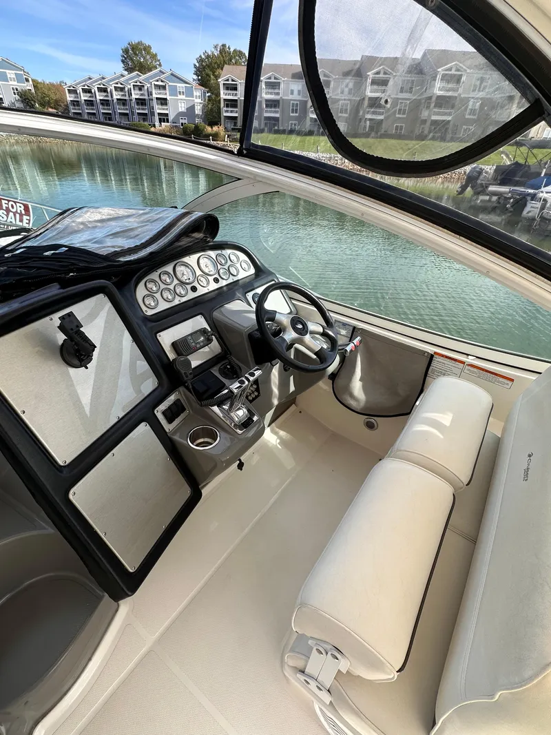 Slide: The Image of 2006 Cruisers Yachts 420 Express cockpit with steering wheel and control panel. - 10