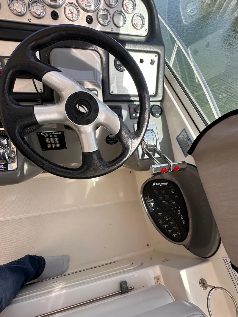 Slide: The Image of 2006 Cruisers Yachts 420 Express helm with steering wheel and control panel. - 11