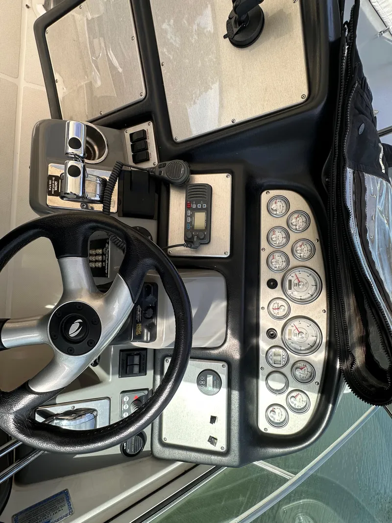 Slide: The Image of 2006 Cruisers Yachts 420 Express helm with steering wheel and instrument panel. - 12