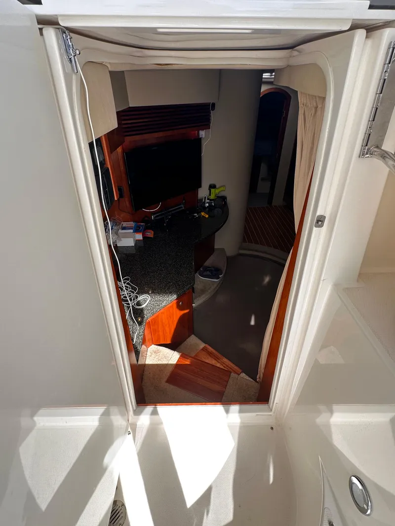 Slide: The Image of Interior view of 2006 Cruisers Yachts 420 Express, showcasing cabin entrance and amenities. - 13