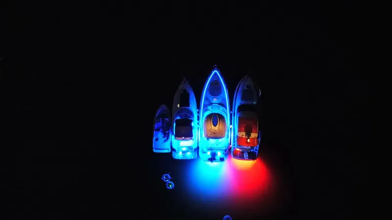 Slide: The Image of Aerial view of illuminated 2006 Cruisers Yachts 420 Express with vibrant blue and red lights. - 15