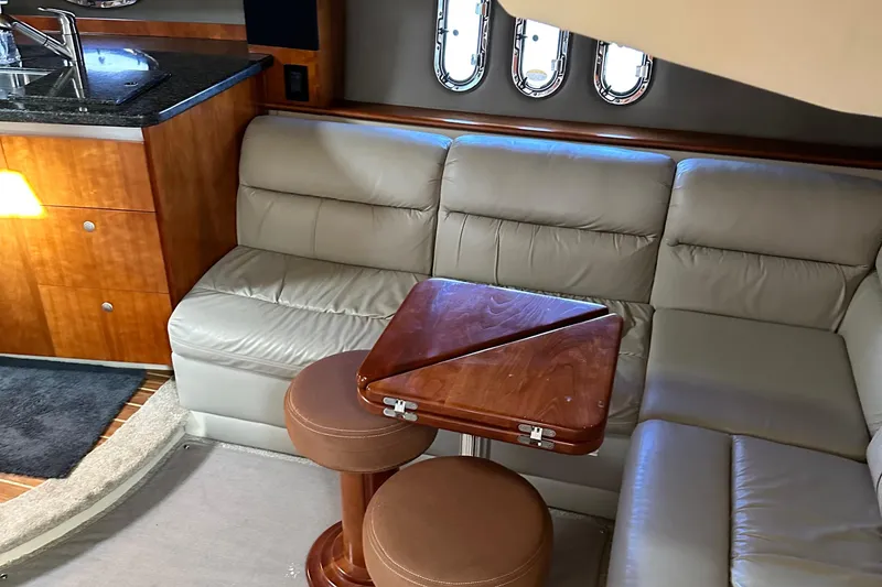 Slide: The Image of 2006 Cruisers Yachts 420 Express interior with leather seating and wooden table. - 19