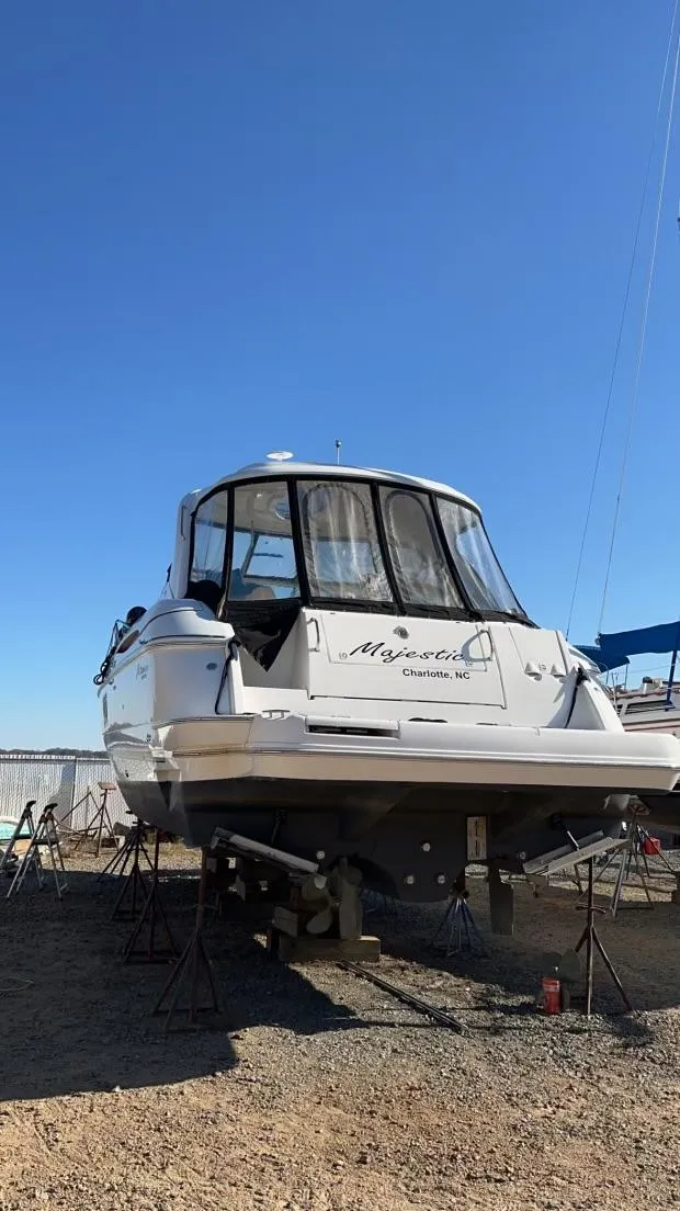 Slide: The Image of 2006 Cruisers Yachts 420 Express on dry dock under clear blue sky. - 2