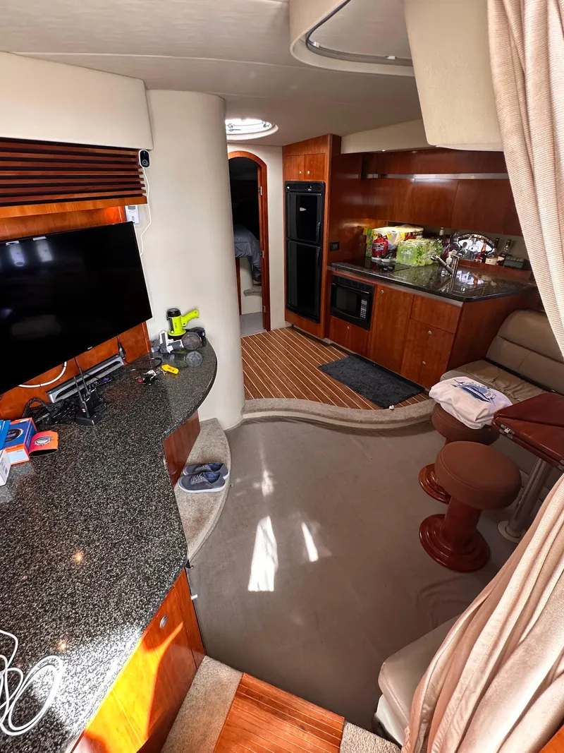 Slide: The Image of Interior of 2006 Cruisers Yachts 420 Express with modern kitchen and entertainment area. - 23