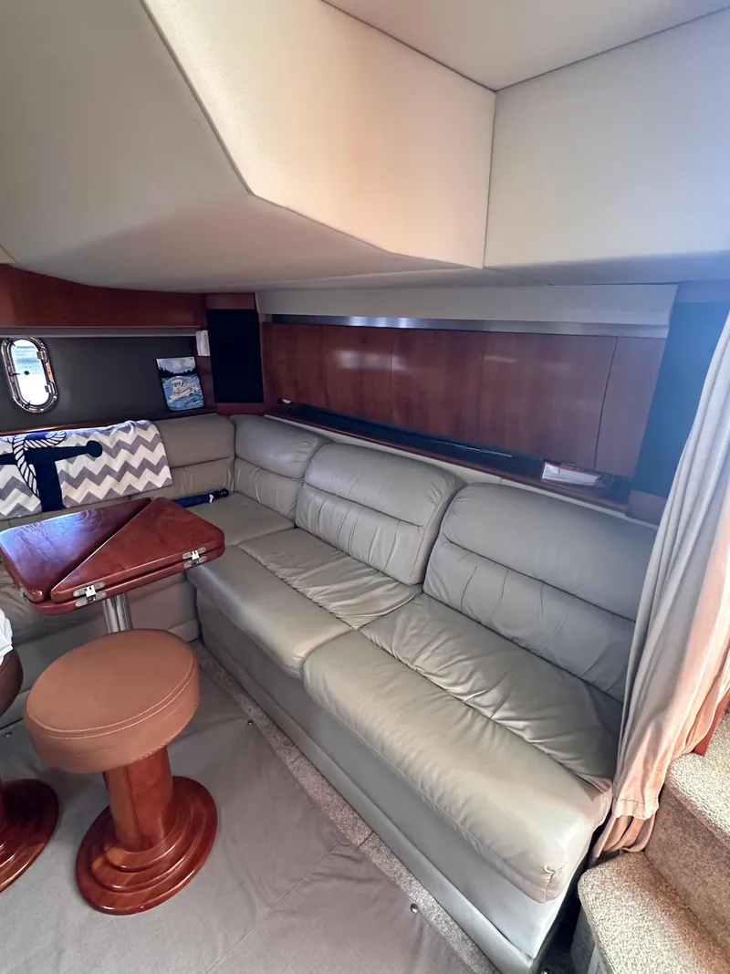 Slide: The Image of Interior of 2006 Cruisers Yachts 420 Express with leather seating and wooden table. - 25