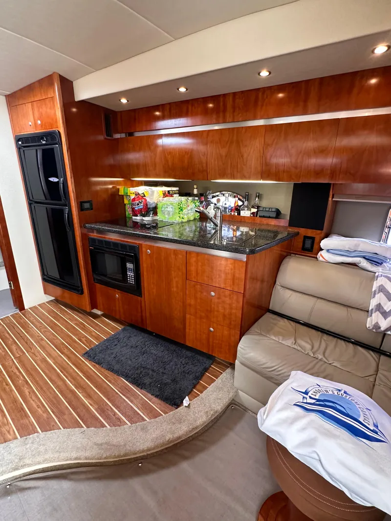 Slide: The Image of 2006 Cruisers Yachts 420 Express interior with modern kitchen and seating area. - 26