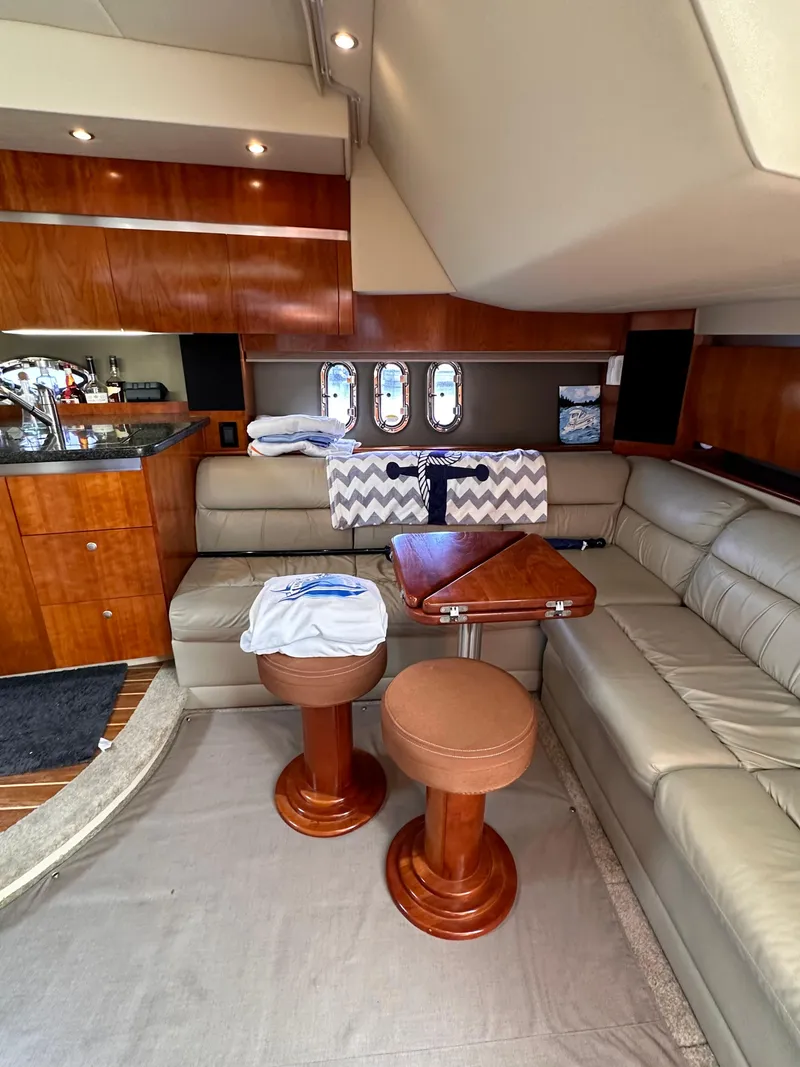 Slide: The Image of Luxurious interior of 2006 Cruisers Yachts 420 Express with leather seating and wooden accents. - 27