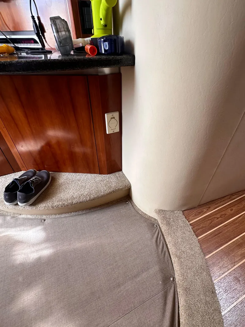 Slide: The Image of Interior of 2006 Cruisers Yachts 420 Express with carpeted steps and wooden cabinetry. - 29