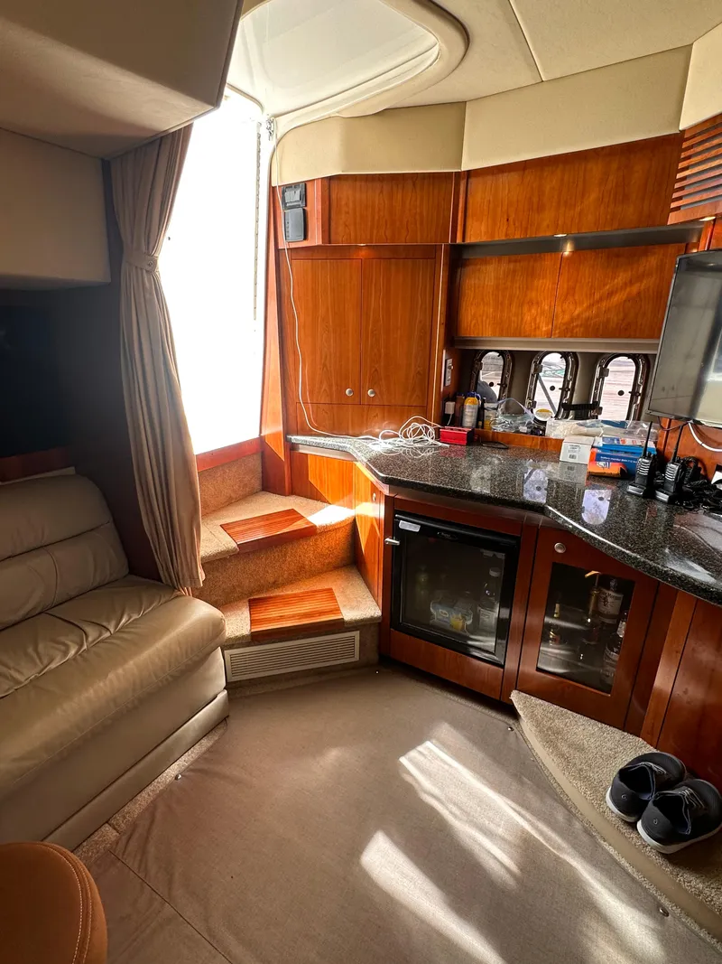 Slide: The Image of Interior of 2006 Cruisers Yachts 420 Express with seating, kitchenette, and natural light. - 31
