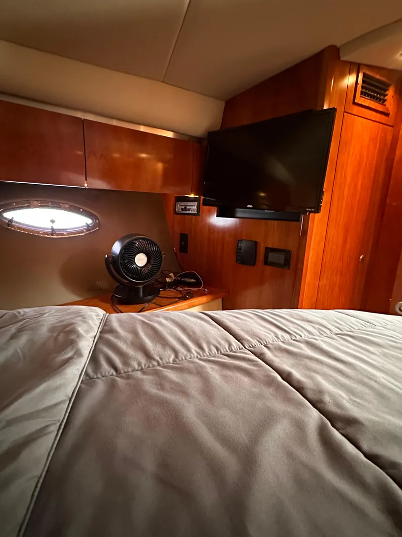 Slide: The Image of 2006 Cruisers Yachts 420 Express cabin interior with TV and fan. - 36