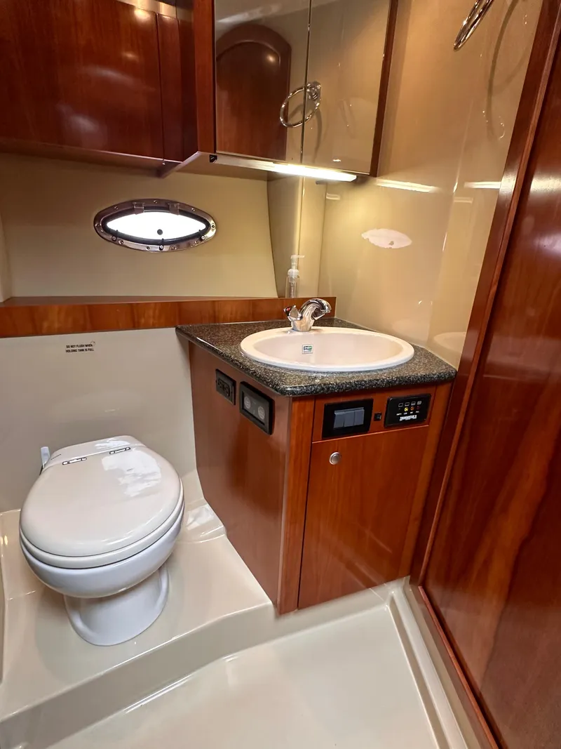 Slide: The Image of 2006 Cruisers Yachts 420 Express bathroom with wood cabinetry and modern fixtures. - 37