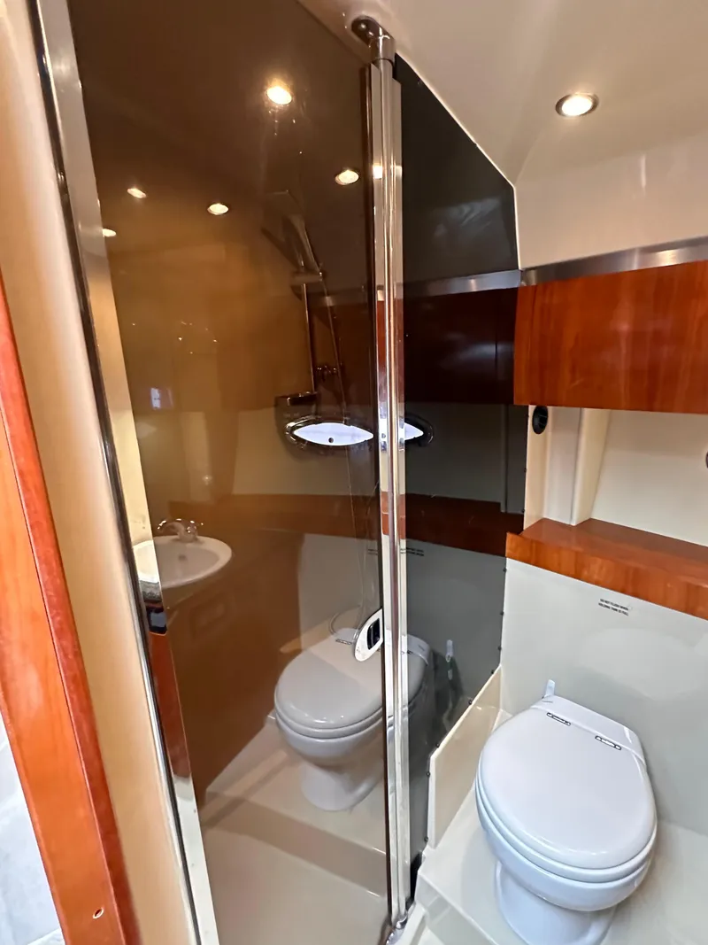 Slide: The Image of 2006 Cruisers Yachts 420 Express bathroom with modern fixtures and wood accents. - 39