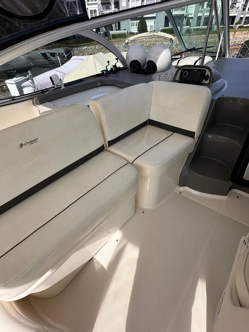 Slide: The Image of 2006 Cruisers Yachts 420 Express interior with white seating and helm. - 8