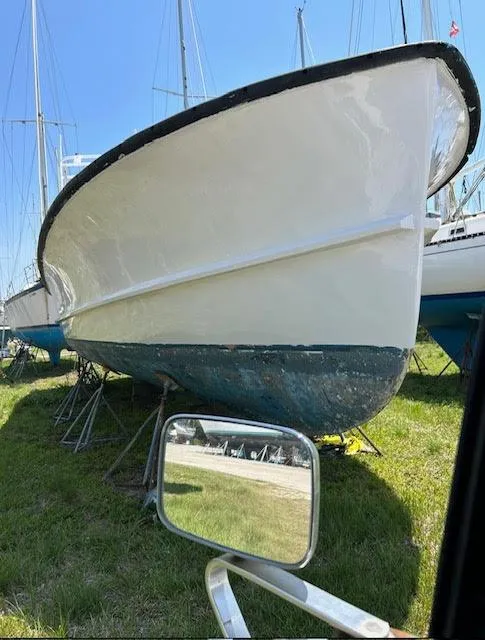 Slide: The Image of Webbers Cove 39 boat from 1969 on land, with a side mirror reflection. - 10