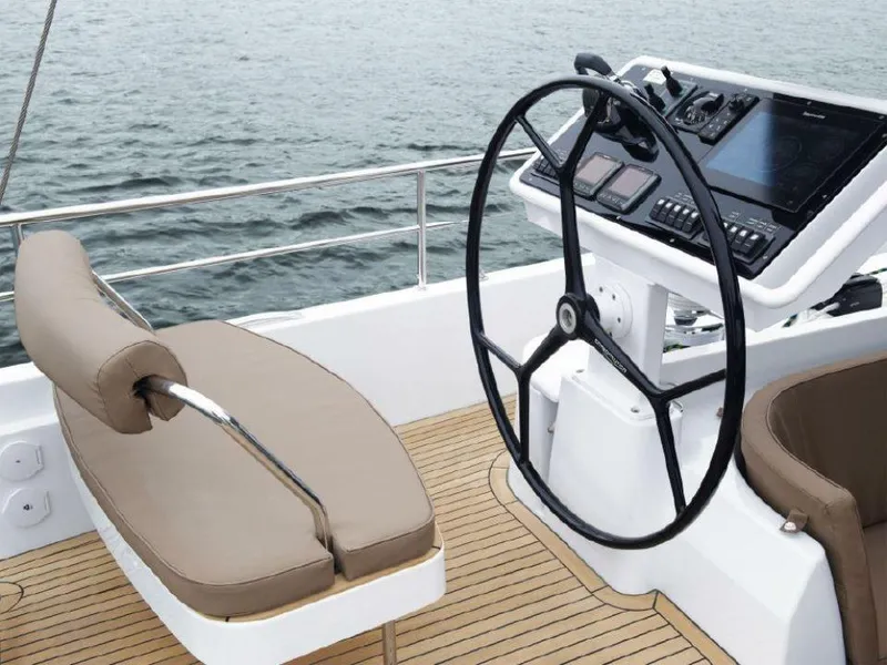 Slide: The Image of Helm of 2025 Moody 54 DS yacht with modern controls and seating. - 12