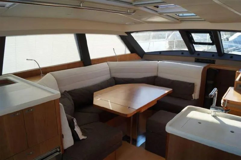 Slide: The Image of Luxurious interior of 2025 Moody 54 DS yacht with modern seating and dining area. - 13