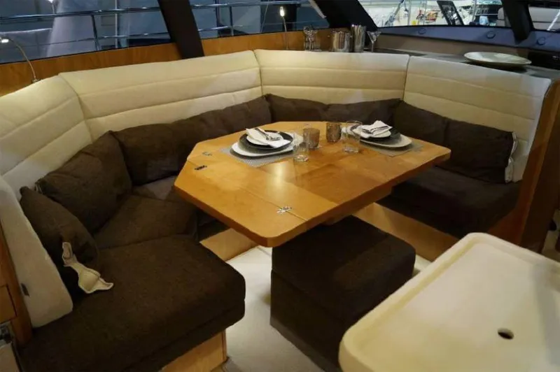 Slide: The Image of Luxurious dining area in 2025 Moody 54 DS yacht with elegant table setting. - 14