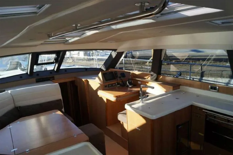 Slide: The Image of Luxurious interior of 2025 Moody 54 DS yacht with modern kitchen and seating area. - 15