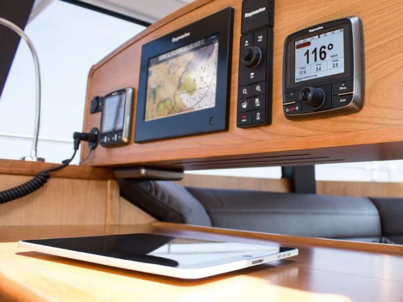 Slide: The Image of Navigation equipment on a 2025 Moody 54 DS yacht, featuring modern control panels and a tablet. - 16