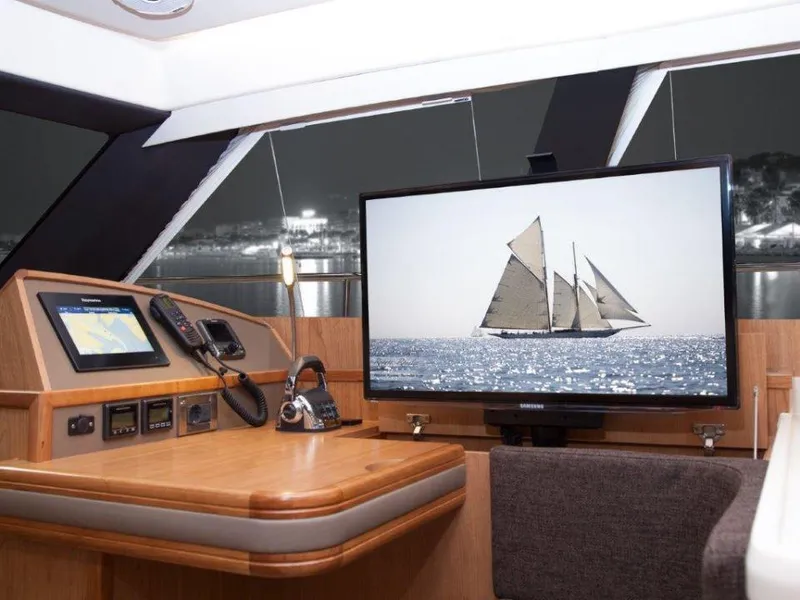 Slide: The Image of Luxurious interior of 2025 Moody 54 DS yacht with navigation and entertainment systems. - 17