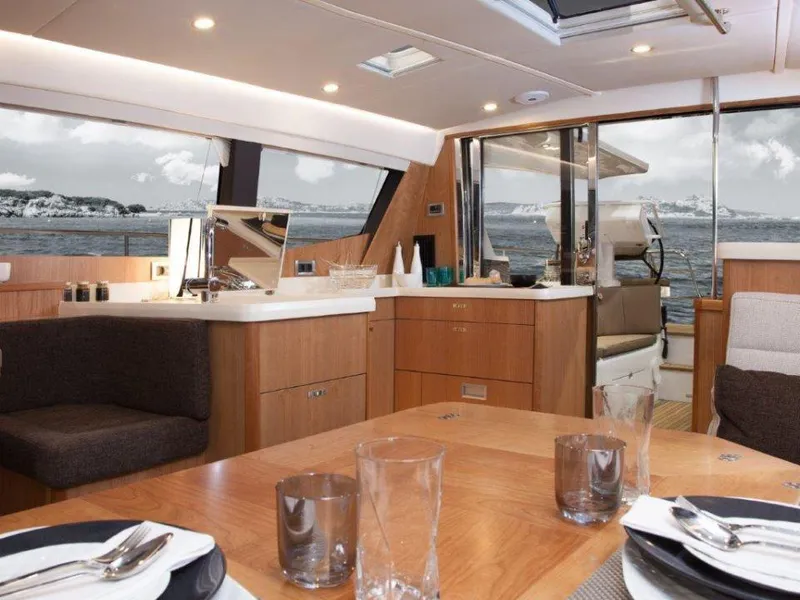 Slide: The Image of Luxurious interior of 2025 Moody 54 DS yacht with elegant dining and kitchen area. - 19
