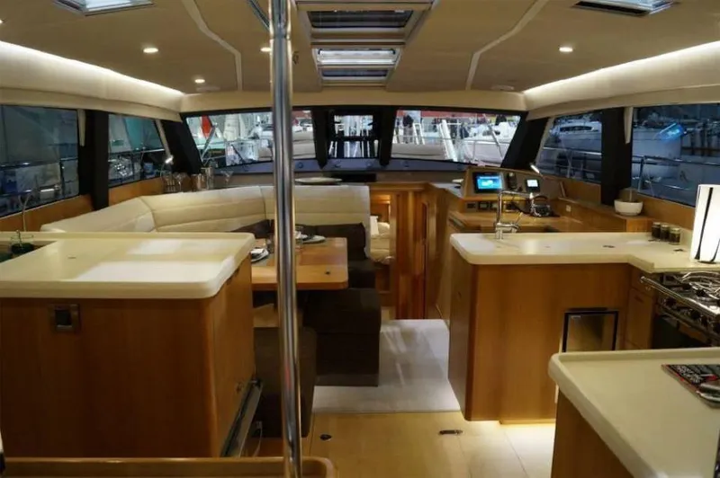 Slide: The Image of Luxurious interior of 2025 Moody 54 DS yacht with modern kitchen and seating area. - 22