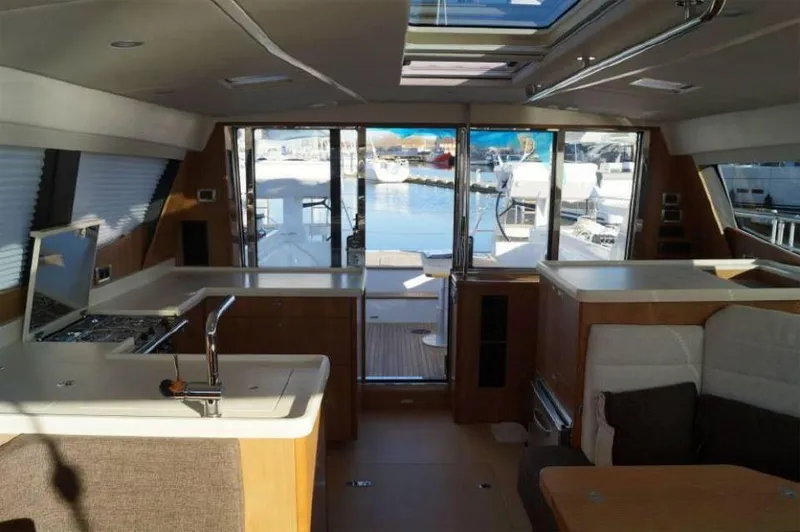 Slide: The Image of Interior of 2025 Moody 54 DS yacht, featuring modern kitchen and spacious seating area. - 23