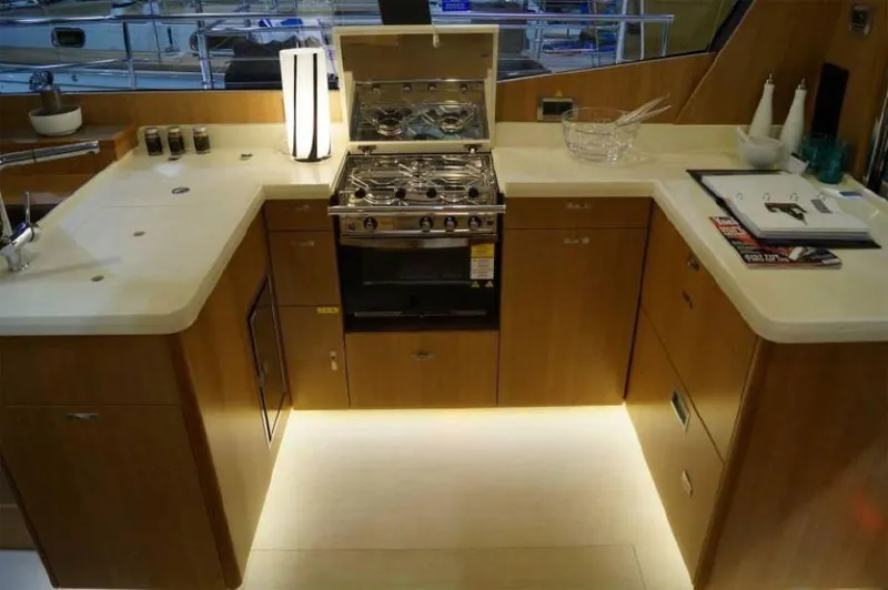 Slide: The Image of Modern kitchen in a 2025 Moody 54 DS yacht with sleek countertops and stainless steel appliances. - 24