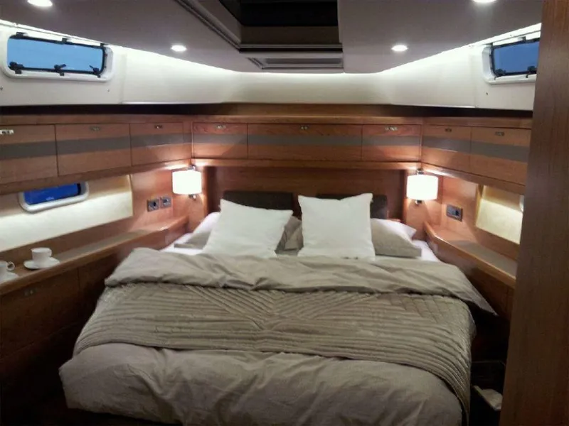 Slide: The Image of Luxurious cabin interior of 2025 Moody 54 DS yacht with cozy bedding and ambient lighting. - 26