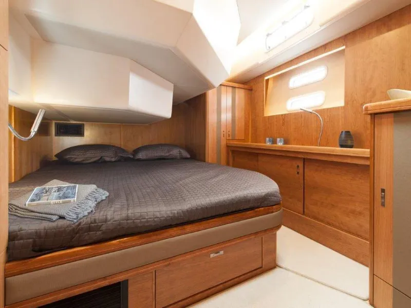 Slide: The Image of Luxurious cabin interior of 2025 Moody 54 DS yacht with wooden furnishings and cozy bedding. - 30
