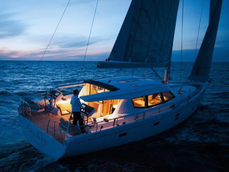 Slide: The Image of Sailing yacht Moody 54 DS 2025 at sunset, illuminated interior, ocean view. - 5