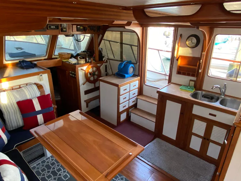 Slide: The Image of Interior of a 1983 DeFever 41 boat with wooden furnishings and nautical decor. - 18