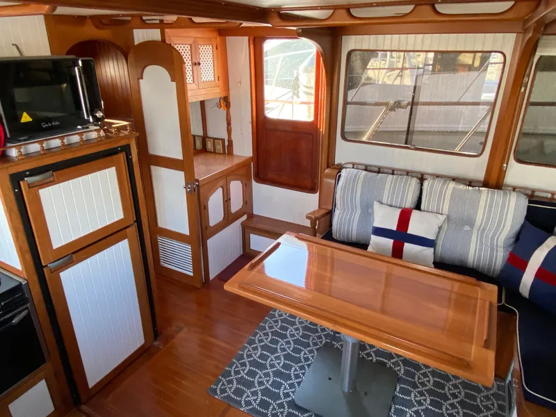 Slide: The Image of Interior of 1983 DeFever 41 yacht with cozy seating and wooden dining table. - 19