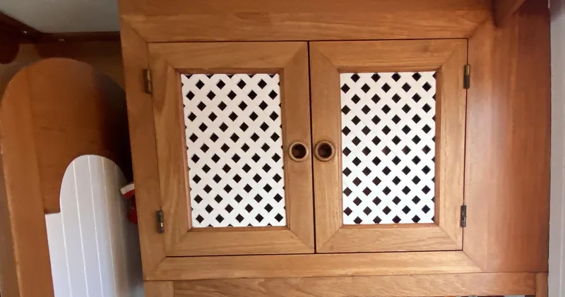 Slide: The Image of Wooden cabinet with lattice doors on a 1983 DeFever 41 boat. - 21